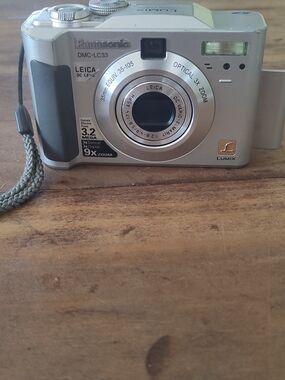 Panasonic Silver Lumix DMC-LC33 Digital Camera and SD Card.